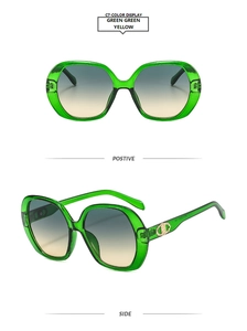 Detail of neon green oversized sunglasses with gradient lenses and gold metal accents