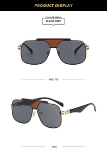 Detail view of large frame sunglasses featuring gold metal cut-out temples and black lenses