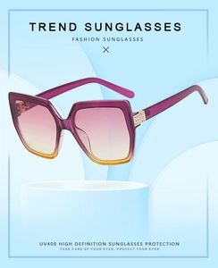 Detail view of purple square cat eye sunglasses with rhinestone accents and UV400 lenses