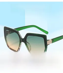 Detail of square sunglasses with gradient lenses and rhinestone-encrusted temples