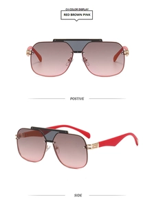 Detail view of pink gradient aviator sunglasses with red arms and black top bar bridge