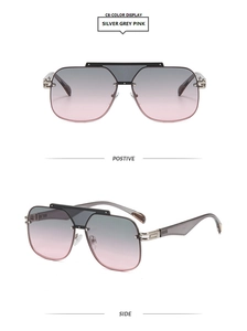 Detail view of stylish oversized pilot sunglasses with pink gradient lenses and metal frames