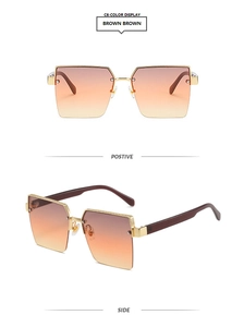 Detail of gradient brown lenses and textured gold metal frame on half-rim sunglasses