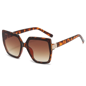 Vintage oversized cat-eye sunglasses with tortoiseshell frames and rhinestone accents