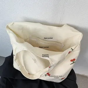 Detailed interior of mesh canvas tote with cherry embroidery and zipper pocket