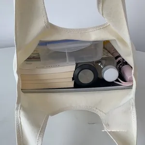 Interior view of the embroidery lace canvas bag showing large capacity for books and tablet