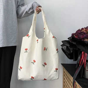 Minimalist canvas tote bag with red cherry embroidery and dual handles for daily use