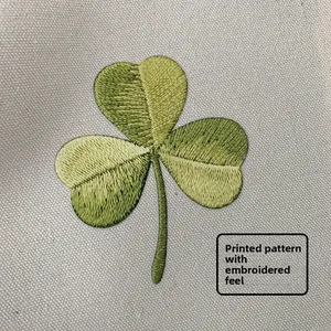 Macro detail of lucky clover print with embroidery texture on canvas shoulder bag