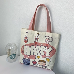Vista dettagliata della borsa in tela con stampa cartoon Happy e chiusura a scatto in rame