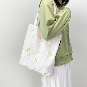 Floral embroidered white canvas tote bag with yellow accents for casual daily style