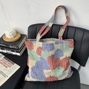 Detail of floral pumpkin embroidery and jacquard texture on vintage tote bag