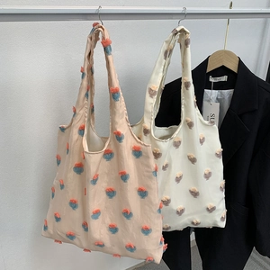 Detail of floral tufted texture and 3D flocking pattern on canvas tote bag