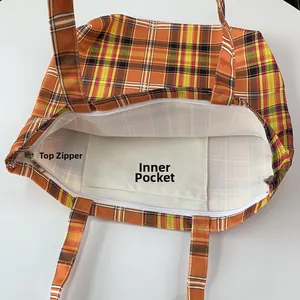 Vue détaillée de l'intérieur du sac cabas à carreaux avec fermeture éclair et poche