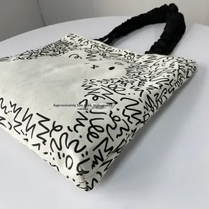 Detail view of the 5cm wide base and premium canvas texture of the graffiti tote bag
