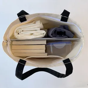Top view of canvas tote bag interior showing large capacity with zipper and inner pocket