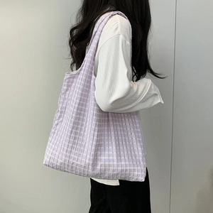 Detail of purple and white checkered tote bag with a unique seersucker crinkle texture
