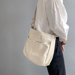 Minimalist cream white canvas crossbody bag for women with adjustable shoulder strap
