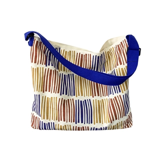 Minimalist canvas tote bag with colorful vertical stripes and wide blue shoulder strap