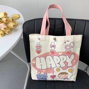 Simpatica borsa tote in tela con manici rosa e stampa HAPPY su una sedia nera