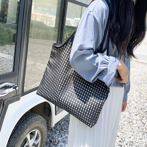 Detail of checkered mesh tote bag featuring breathable fabric and large capacity