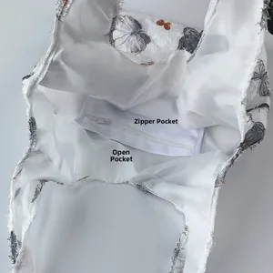 Internal view showing a zippered pocket and an open compartment in a butterfly print bag
