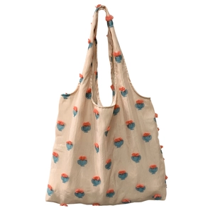 Minimalist beige canvas tote bag featuring floral jacquard embroidery and large capacity
