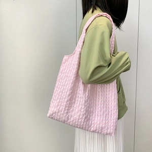 Detail shot of the pink checkered canvas tote bag showing lightweight textured fabric