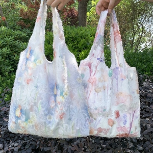 Detail of floral plush tote bags featuring 3D jacquard fur trim and soft texture