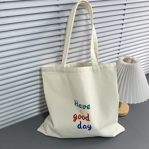 Detail of canvas tote bag with Have a good day print and premium fabric texture