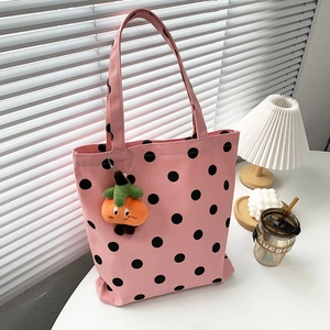 Pink canvas tote bag with black polka dots and cute orange persimmon plush pendant charm