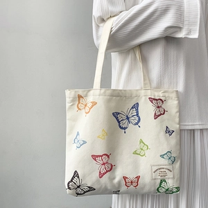 Minimalist canvas tote bag with colorful butterfly prints and comfortable shoulder straps