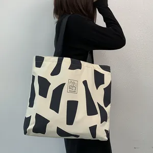 Detail of canvas tote bag with geometric print and Good Student rabbit patch