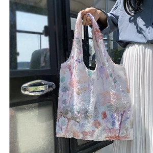 Detail of the 3D floral lace embroidery and soft fabric texture on the white canvas tote bag
