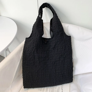 Close-up of black checkered texture fabric on large capacity canvas tote bag for women