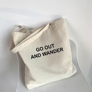 Minimalist cream canvas tote bag with 'Chu Qu Lang' print placed on a white chair