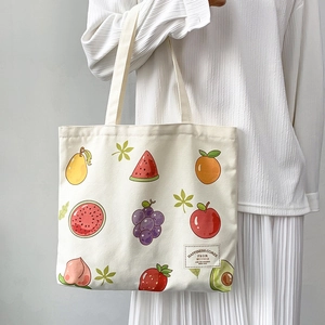 Detail of printed canvas tote bag featuring various colorful cartoon fruit patterns