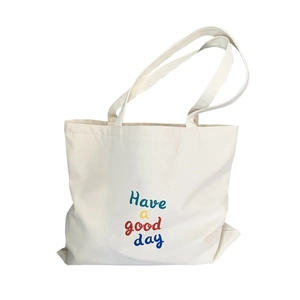 Minimalist large canvas tote bag featuring 'Have a good day' colorful printed lettering