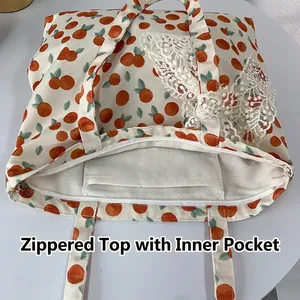 Floral canvas tote bag with orange print, white lace trim and secure zipper closure