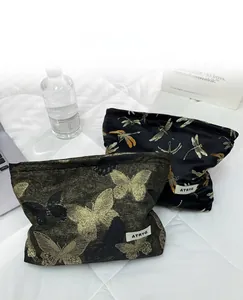 Detail of high-quality golden butterfly embroidery on the premium fabric cosmetic bag