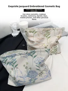 Floral embroidered cotton cosmetic bag with metallic zipper and premium jacquard texture