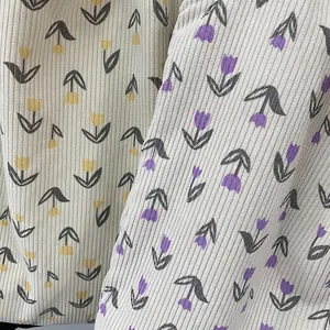 Floral corduroy tote bag showing yellow and purple tulip patterns on soft fabric texture