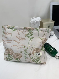 Detail of floral canvas storage bag with ATRYG label and vintage flower pattern