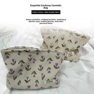 Detail view of floral corduroy cosmetic bag with tulip pattern and zipper closure