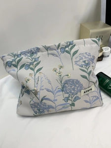 Detailed macro view of the jacquard fabric texture and blue floral embroidery on the bag