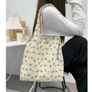 Corduroy tote bag for women with yellow tulip floral pattern in minimalist indoor setting