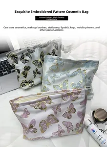Detailed embroidery of gold butterflies on portable cosmetic organizers set