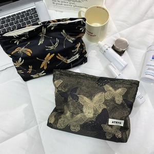 Stylish makeup bags with golden butterfly embroidery and high capacity for skincare storage