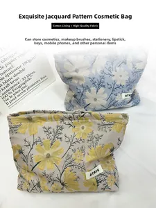 Detail of floral jacquard cosmetic bags with woven label and soft cotton lining texture
