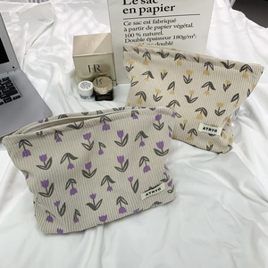 Detail of floral corduroy makeup bags with tulip prints and soft vintage texture