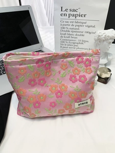 Trousse à maquillage jacquard rose à motif floral avec fermeture éclair et logo